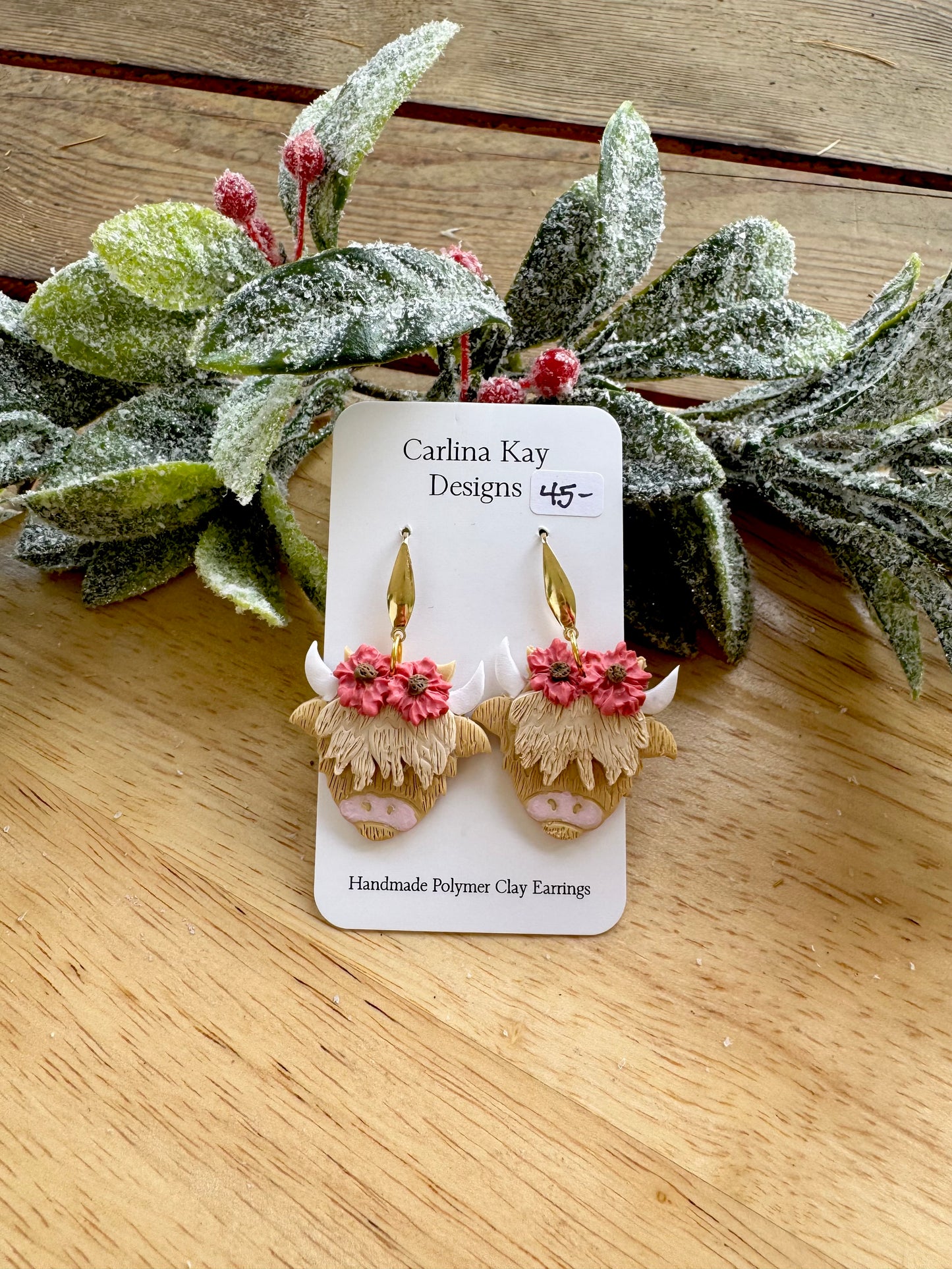 Cream highland cows with Medium pink flowers